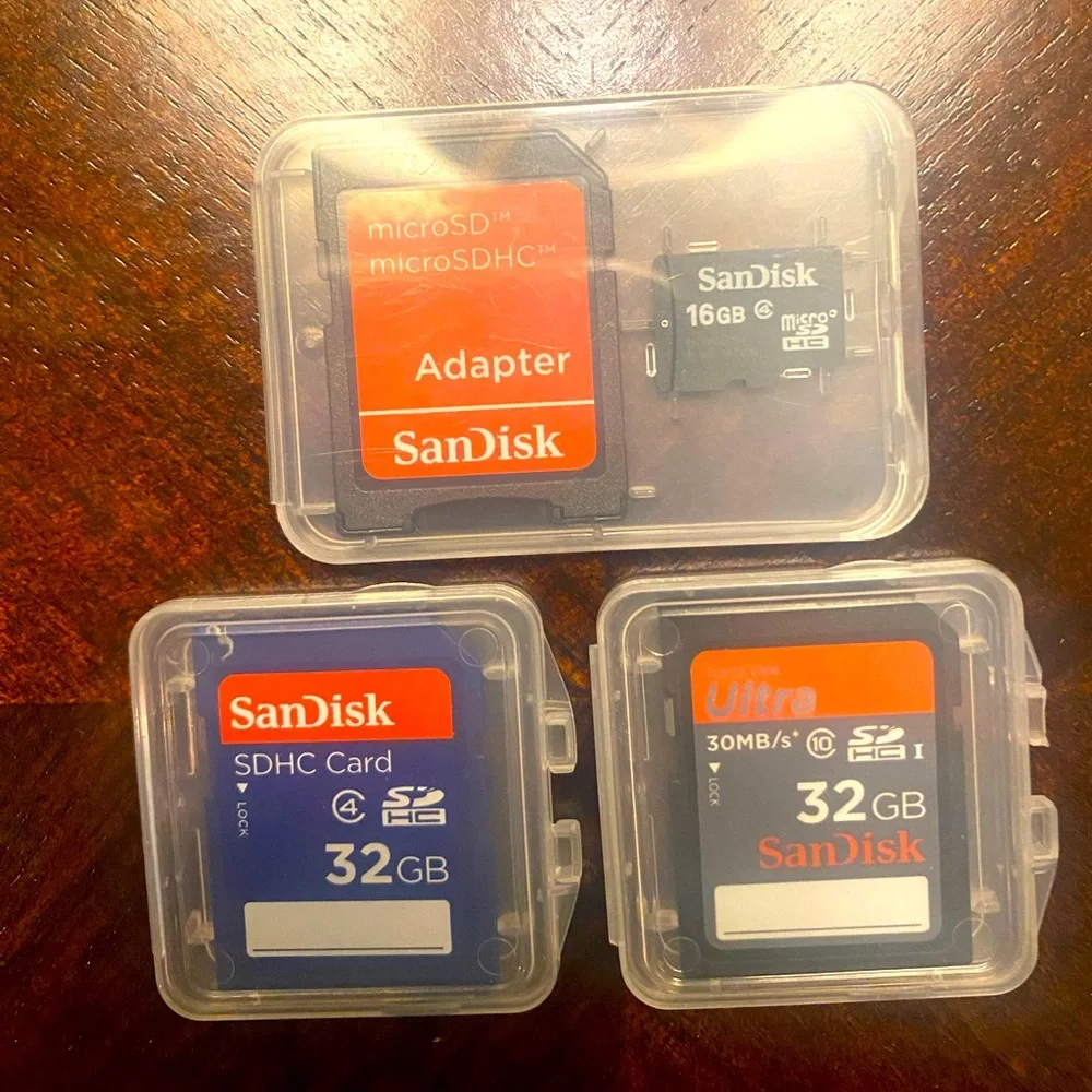 THREE SANDISK MEMORY CARDS 2 32G AND 1 16G WITH MICO ADAPTER BRAND NEW